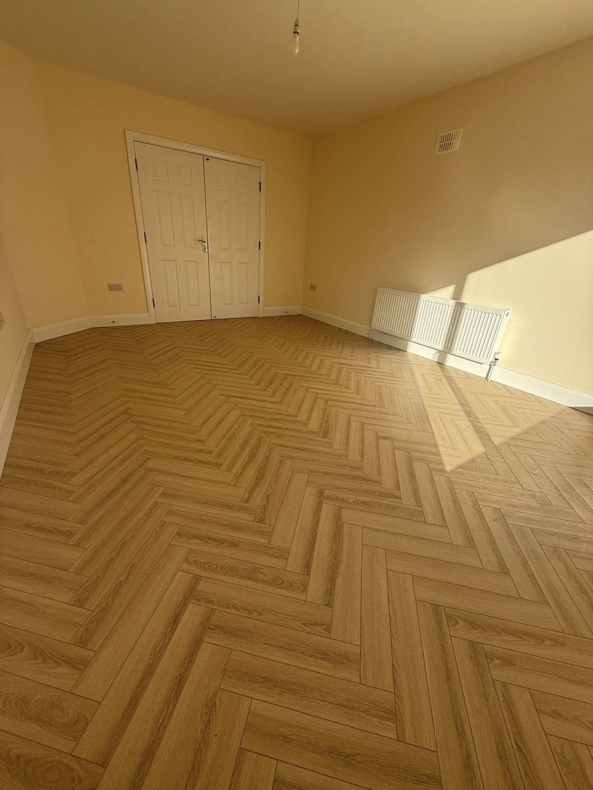 Craftsman installing oak plank flooring