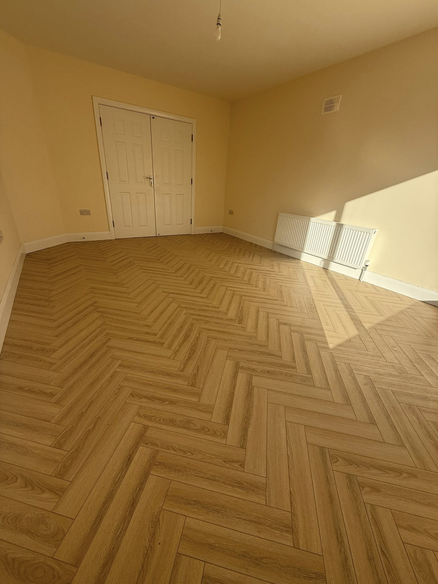 Craftsman installing oak plank flooring
